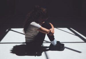 Make choices that are healthy for your mind. Shot of a young woman sitting in an asylum.
