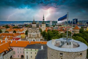 Aerial shot of the Estonian flag over the beautiful city with old buildings