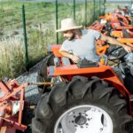 Agronomist choosing tractor at the agricultural shop