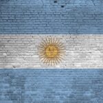 Argentina flag depicted in paint colors on old brick wall close up