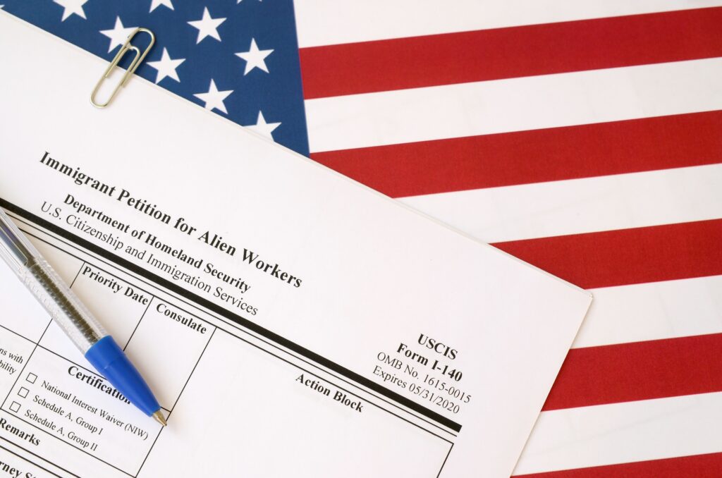 I-140 Immigrant petition for alien workers blank form lies on United States flag