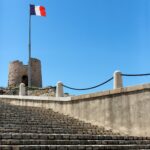 French flag and Marseille Castle - France